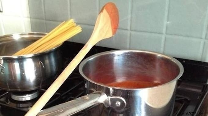 Genius Kitchen Hack: Hang Your Sauce-Covered Spatula on the Pan Handle to Stay Mess-Free